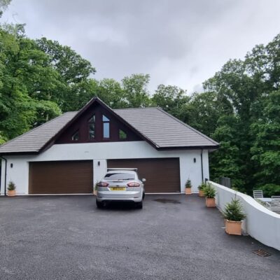 Triple garage build with two storey living space designed by MHM Design Ltd.