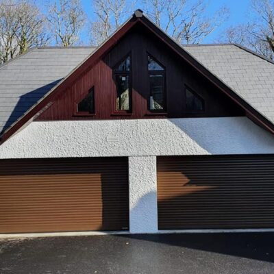 External view of triple garage with living space designed by MHM Design Ltd.